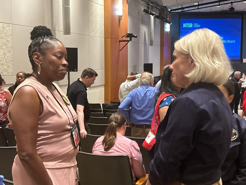 Gwen Duggins, mother of Kiah Duggins who perished on AA Flight 5342, speaks to NTSB Chair Jennifer Homendy on a break in the hearings.